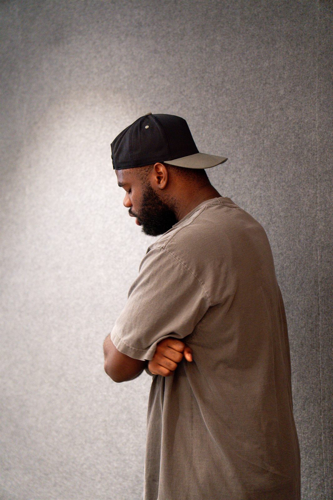 Portrait of an attendee against a textured wall