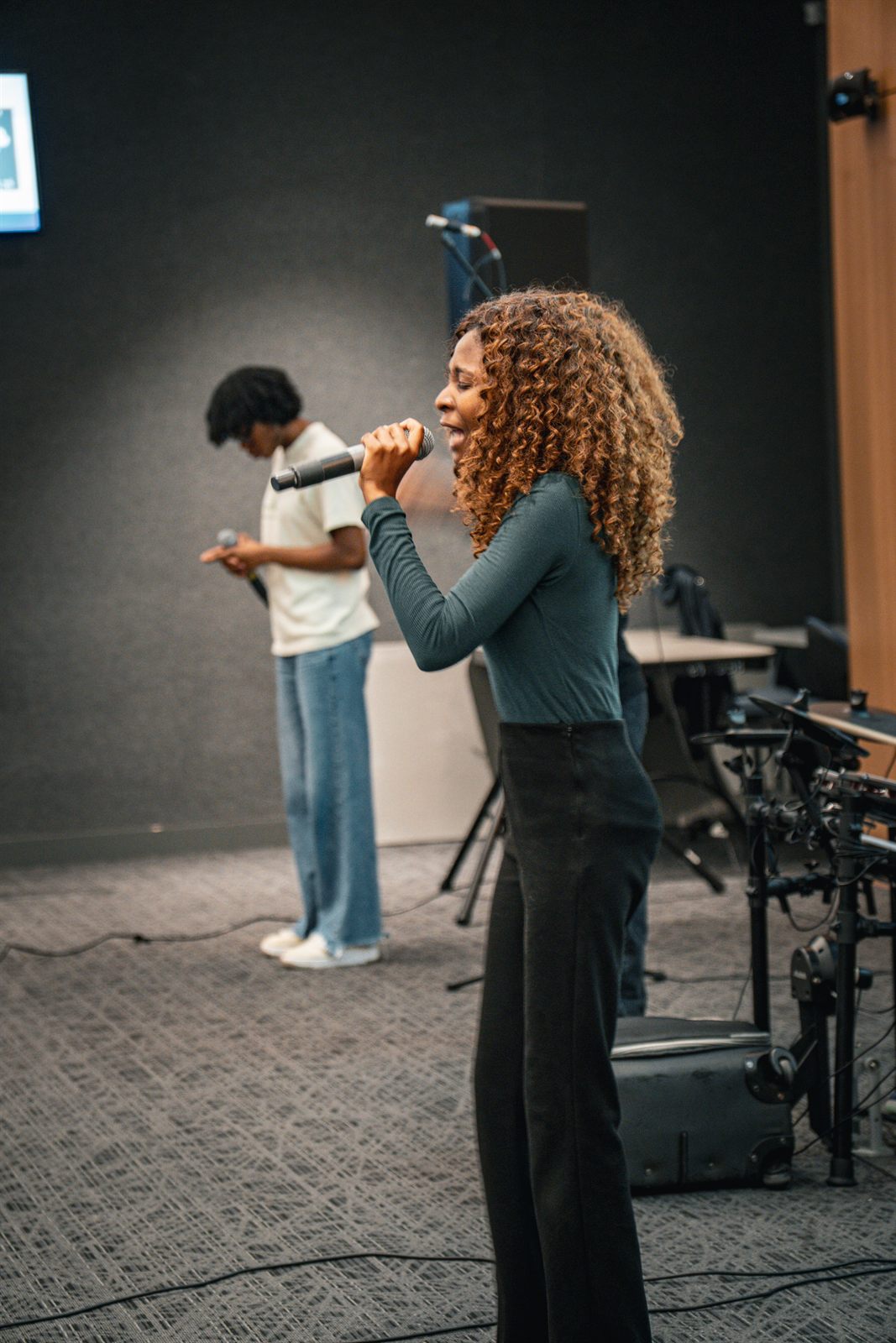 Vocalist singing into a handheld microphone