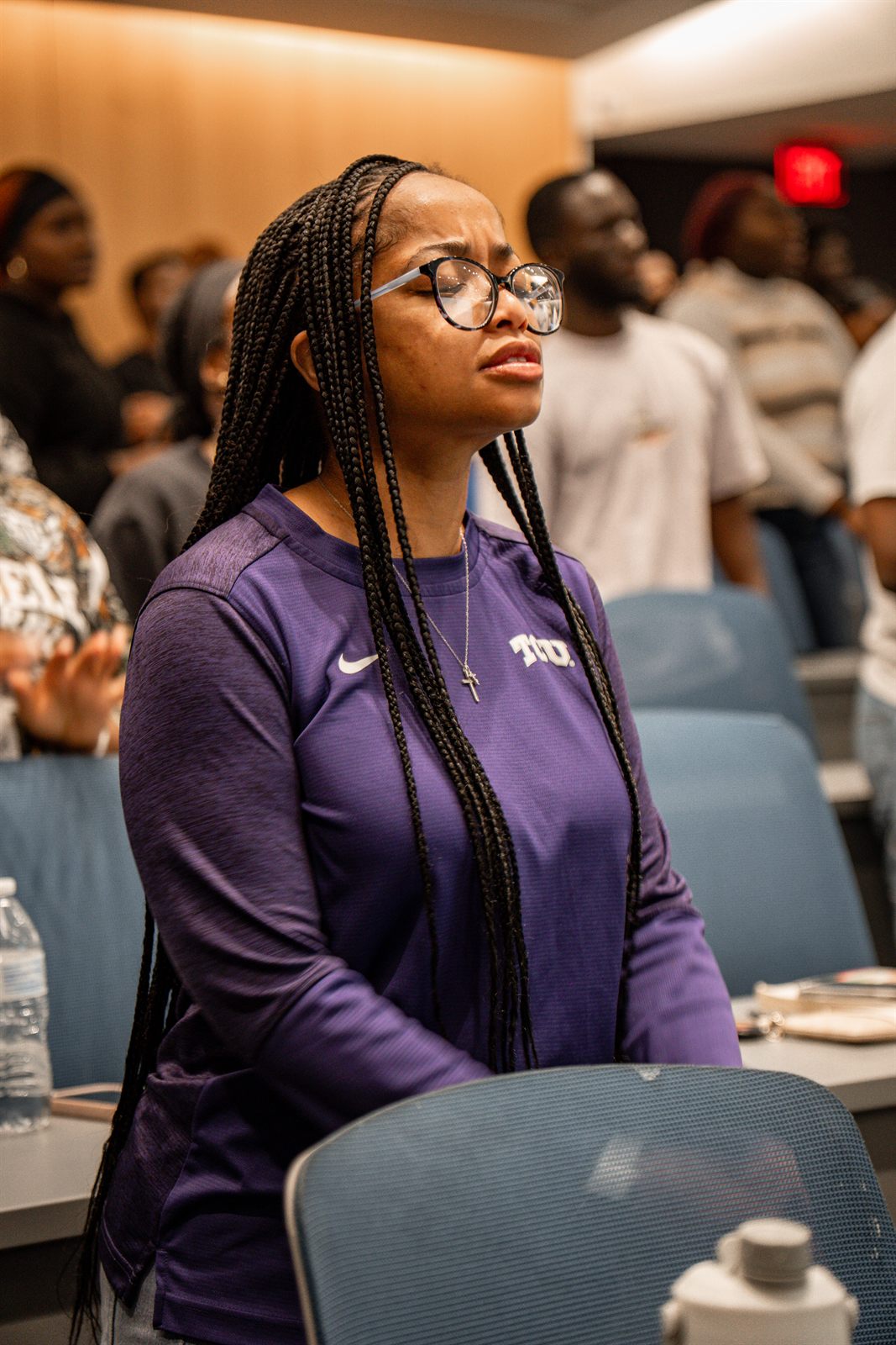 Attendee with eyes closed during the service