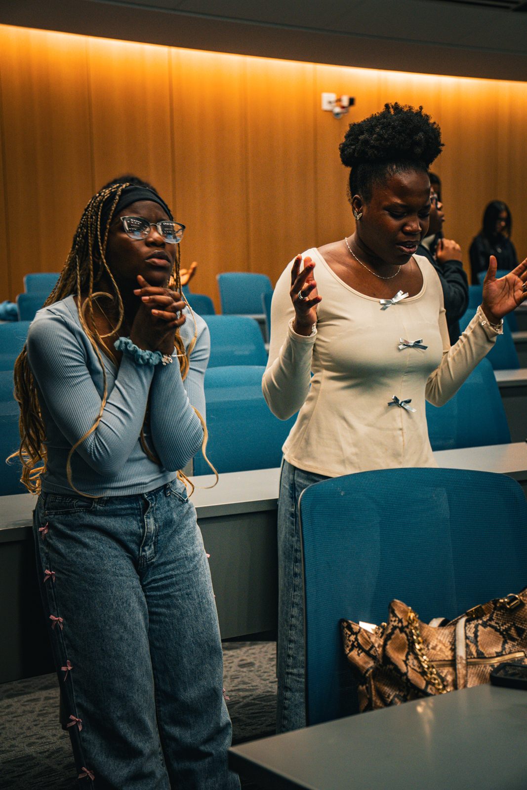 Two attendees singing together in the aisle