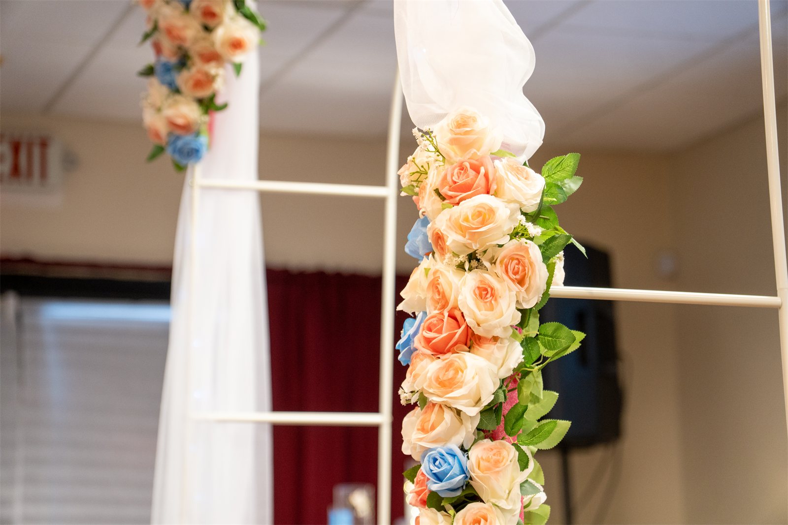 Close detail of the floral arch in peach and blue